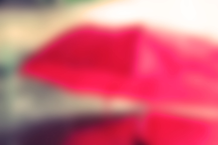 Blurred image of red umbrella and raining.の写真素材