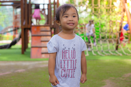 Cute girl standing at playgroundの写真素材