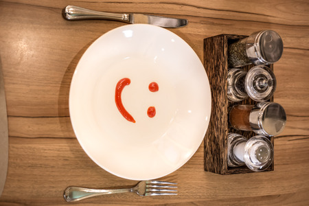 emotional smile on dish made from ketchup sauceの写真素材