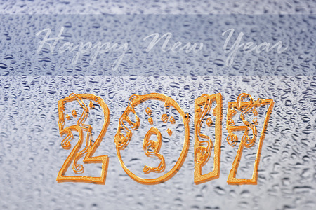 Happy New Year 2017 on rain drops on glass backgroundの写真素材