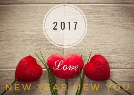 2017 Happy New Year words on red heart and wooden background
