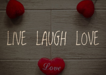 Live Laugh Love on red heart and wooden background.の写真素材