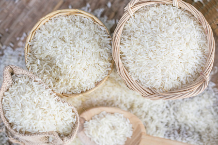 White uncooked rice on wooden surface.の写真素材
