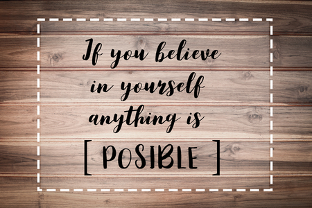 If you believe in yourself anything is POSSIBLE words on brown wooden wall.の写真素材