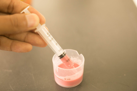 liquid drug with syrup in syringe for child patient.の写真素材