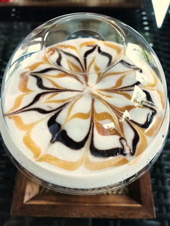 Cup of ice coffee with beautiful Latte art.
