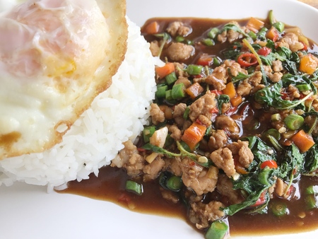 rice topped with stir-fried pork and basil.の写真素材