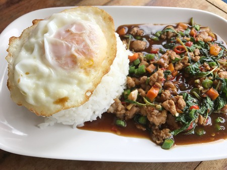 rice topped with stir-fried pork and basil.の写真素材