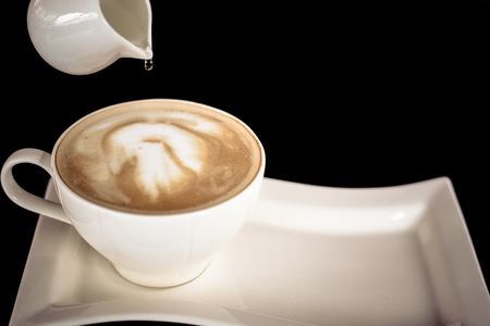 Beautiful late coffee on black wood background.の写真素材