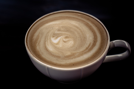 Beautiful late coffee on black wood background.の写真素材