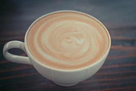 Beautiful late coffee on black wood background.の写真素材