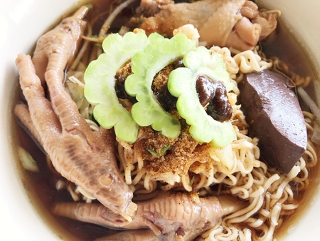 Braised chicken soup with bitter gourd noodle.の写真素材