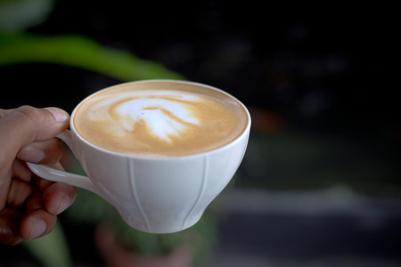 Beautiful late coffee on black wood background.の写真素材