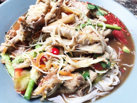 green papaya spicy salad with boiled Chicken legs.の写真素材