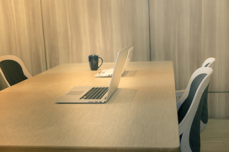 Office workplace with laptop, smart phone, cup of coffee on Comfortable work table, wood tableの写真素材