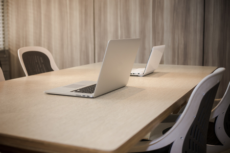 Office workplace with laptop, smart phone, cup of coffee on Comfortable work table, wood tableの写真素材
