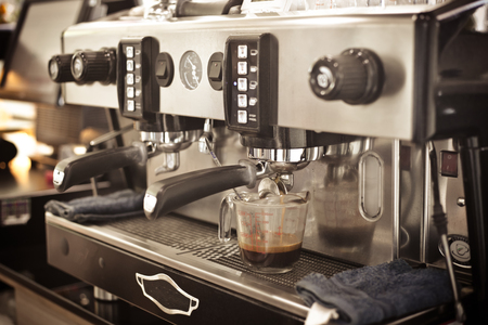 Close up barista hands making coffee by machine in coffee cafe.の写真素材