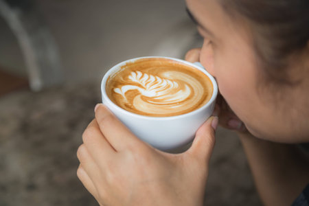 People drinking hot coffee, art latte coffee.の写真素材