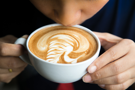 People drinking hot coffee, art latte coffee.の写真素材