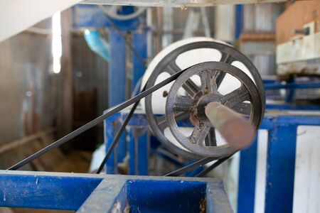 The rice mill machine systems during working. Some part of rice came out from the paddy separator machine.の写真素材