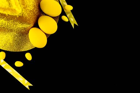 Red Eggs/Yellow Eggs and gift decoration on black background.の写真素材