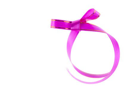 Pink ribbon with bow isolated on white background.の写真素材
