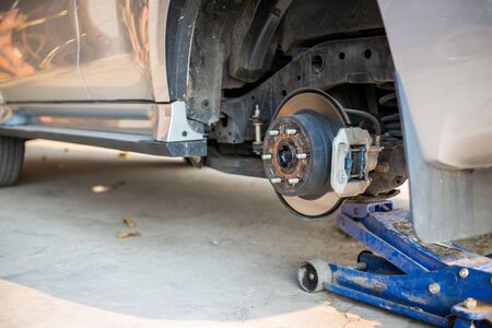Mechanic changing wheel on car with pneumatic wrench, Photo of car wheel.の写真素材