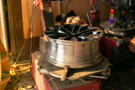 Mechanic changing wheel on car with pneumatic wrench, Photo of car wheel.の写真素材