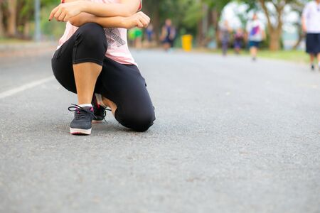 Young runner woman resting on the road.の写真素材
