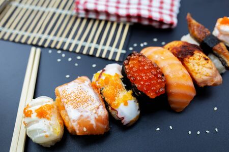 Sushi with chopsticks, Japanese sushi with soy sauce and wasabi.の写真素材