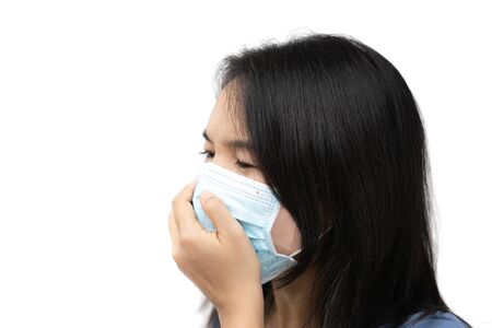 Asian woman wearing facial mask for protection from air pollution or virus epidemic on white background.の写真素材