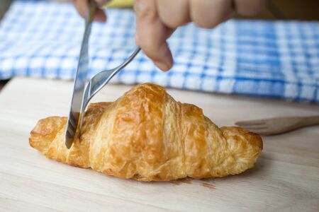 Freashly baked tasty croissants on wooden background.の写真素材