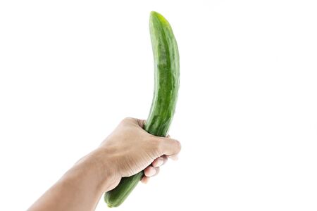 Hand holding a long green cucumber white background.の写真素材