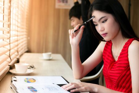 Young asian woman working with friendの写真素材
