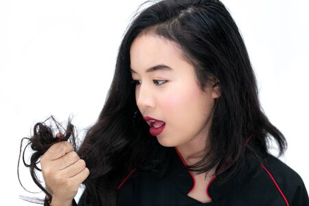 Asian girl looking her hair. Healthy black Hair concept.の写真素材