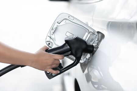 filling gas pump, Woman refilling gasoline oil with fuel at the refuel station.の写真素材