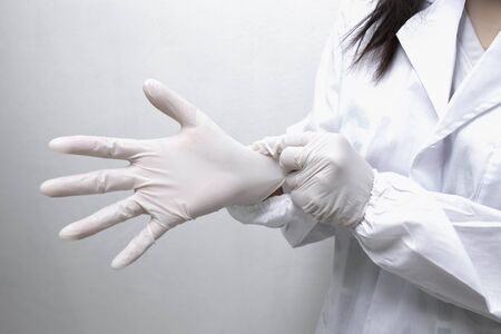 scientist or doctor with gloves researching and examining hemp oil in a greenhouse. Concept of herbal alternative medicine.の写真素材