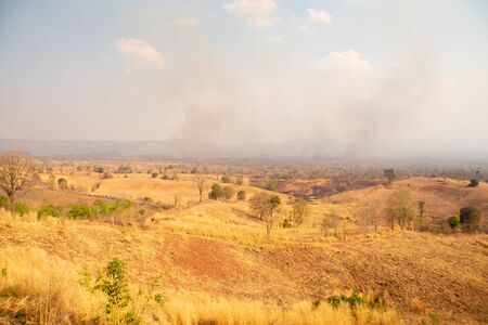 Fire in mountain forest. Aerial view forest fire and smoke on slopes hills. Natural disaster fire in Thailand.の写真素材