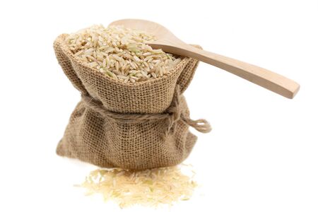 Raw brown rice in brown sack, healthy food background.の写真素材