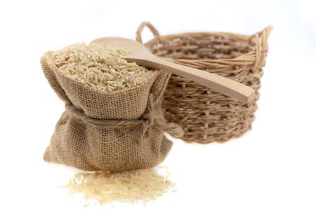 Raw brown rice in brown sack, healthy food background.の写真素材