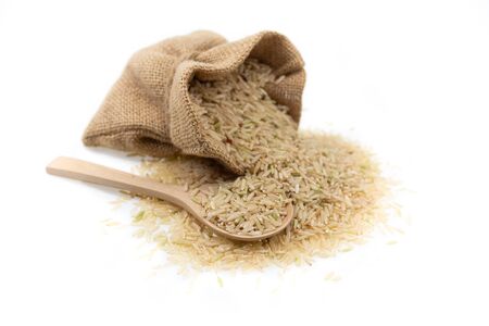 Raw brown rice in brown sack, healthy food background.の写真素材