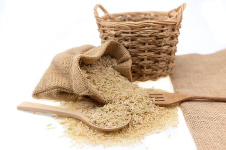 Raw brown rice in brown sack, healthy food background.の写真素材
