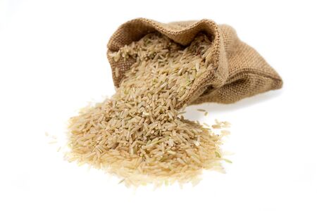 Raw brown rice in brown sack, healthy food background.の写真素材