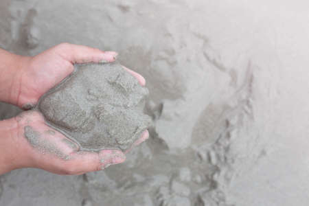 Sand on the beach and child's hand.の写真素材