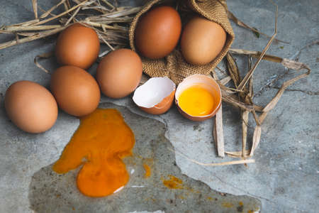 Eggs in a basket and broken egg.の写真素材