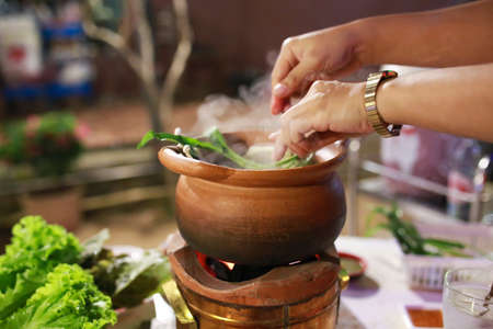 Close-up view of shabu shabu in hot pot. Fresh sliced meat, egg and vegetables, Thailand hotpot style.の写真素材