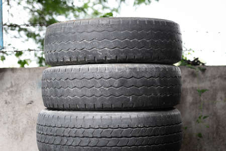 Old tire is placed on the tire storage rack in home.の写真素材