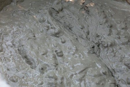 Concrete mix. Construction workers are mixing cement to build walls on the construction site.の写真素材