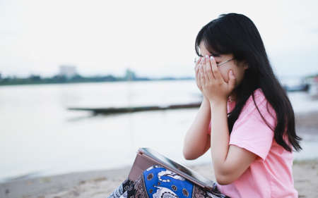 Cute Asian girl feel relax on the beach.の写真素材