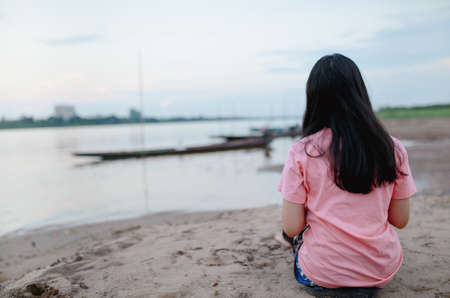 Cute Asian girl feel relax on the beach.の写真素材